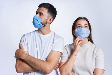 Image showing Young couple wearing medicine masks