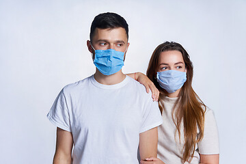 Image showing Young couple wearing medicine masks