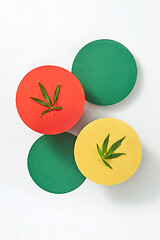 Image showing Multicolored round cards with marijuana leaves on a light grey background.