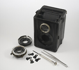 Image showing old vintage disassembled camera, screwdriver and tweezers