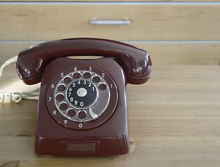 Image showing burgundy vintage traditional dial telephone