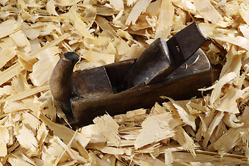 Image showing a lot of fresh wood shavings and vintage planer