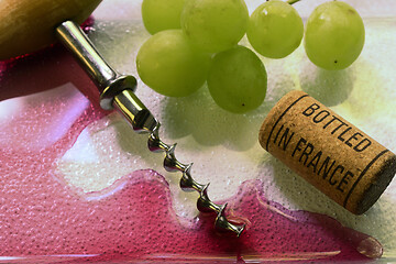 Image showing vintage old corkscrew, wine and wine cork 