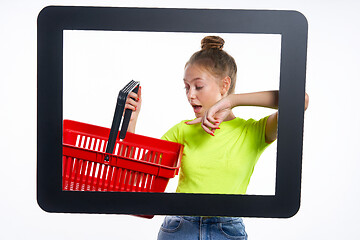 Image showing Online shopping concept. Trendy teen girl with empty shopping basket
