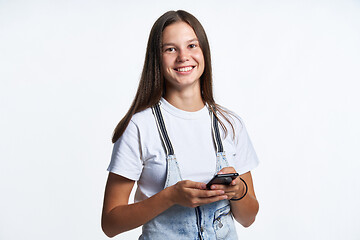 Image showing Smiling teen girl with smart phone in hands,