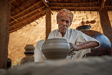 Image showing Potter at work makes ceramic dishes. India, Rajasthan.