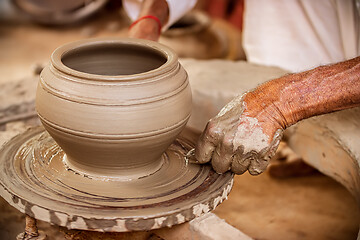 Image showing Potter at work makes ceramic dishes. India, Rajasthan.