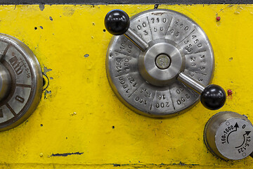 Image showing Old yellow lathe machine with a lot of handles.