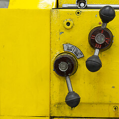 Image showing Old yellow lathe machine with a lot of handles.