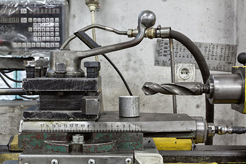 Image showing Old yellow lathe drilling machine with a lot of handles.