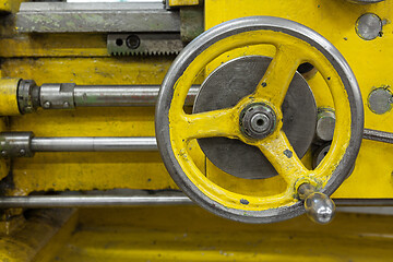 Image showing Old yellow lathe machine with a lot of handles.