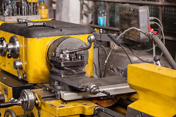 Image showing Old yellow lathe machine with a lot of handles.
