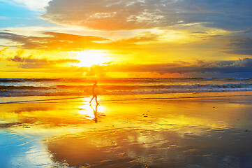 Image showing Surfer in sunbeams. Bali island