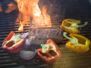 Image showing steak with vegetables on a barbecue