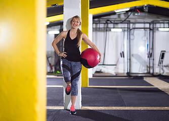 Image showing portrait of woman with red crossfitness ball