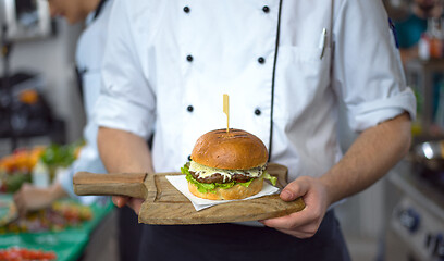 Image showing chef finishing burger