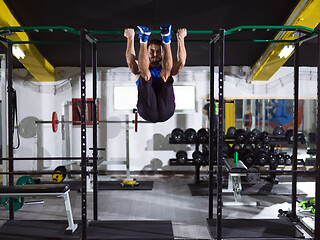 Image showing man doing pull ups on the horizontal bar