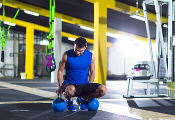 Image showing Young strong man doing pushups