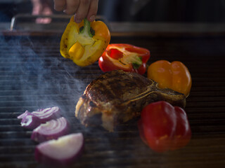 Image showing chef cooking steak with vegetables on a barbecue