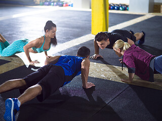 Image showing young healthy people doing pushups