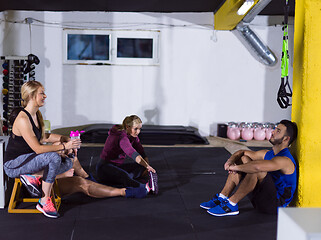 Image showing young athletes sitting on the floor and relaxing