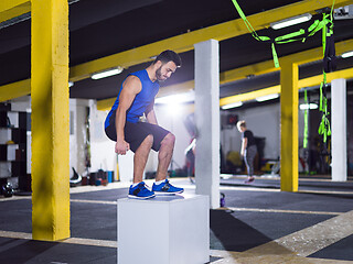 Image showing man working out jumping on fit box