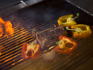 Image showing steak with vegetables on a barbecue