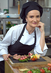 Image showing female Chef preparing beef steak