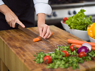 Image showing chef hands cutting carrots