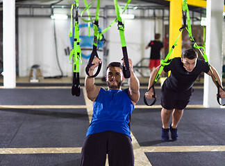 Image showing men working out pull ups with gymnastic rings