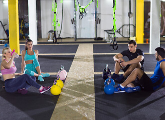 Image showing young athletes sitting on the floor and relaxing