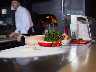 Image showing chef preparing dough for pizza