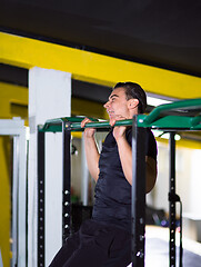 Image showing man doing pull ups on the horizontal bar