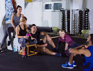 Image showing young athletes sitting on the floor and relaxing