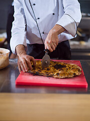 Image showing chef cutting baked bread