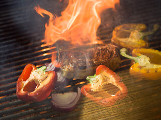 Image showing steak with vegetables on a barbecue