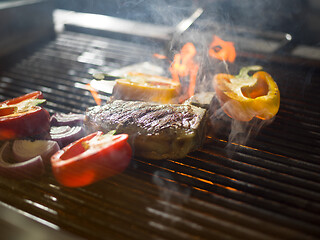 Image showing steak with vegetables on a barbecue