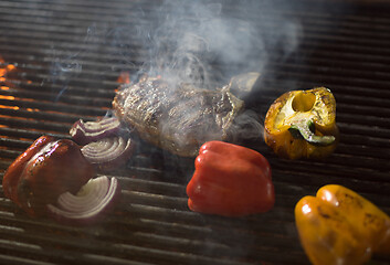 Image showing steak with vegetables on a barbecue