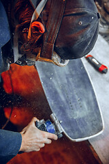 Image showing Carpenter using circular saw for cutting wooden boards.