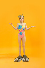 Image showing Girl wearing swimwear standing with snorkelers and flippers