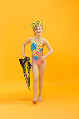 Image showing Girl wearing swimwear standing with snorkelers and flippers