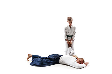 Image showing Man and teen boy fighting at aikido training in martial arts school