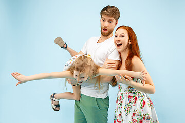 Image showing Happy parent with daughter at studio isolated on blue background