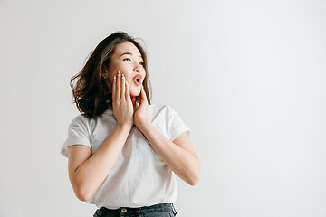 Image showing Isolated on pink young casual woman shouting at studio