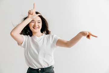 Image showing Losers go home. Portrait of angry woman showing loser sign over forehead