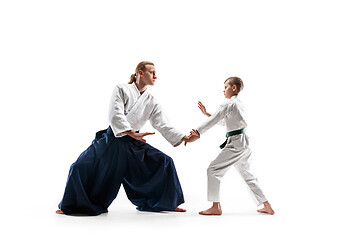 Image showing Man and teen boy fighting at aikido training in martial arts school