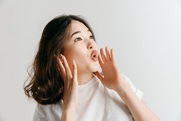 Image showing Isolated on pink young casual woman shouting at studio