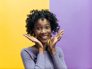 Image showing The happy african woman standing and smiling against gray background.