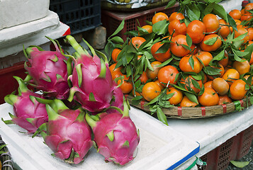 Image showing Dragon fruits and tangerines at a market in Vietnam