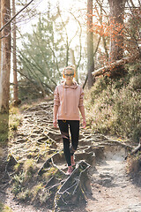 Image showing Young fit woman hiking in nature. Adventure, sport and exercise.